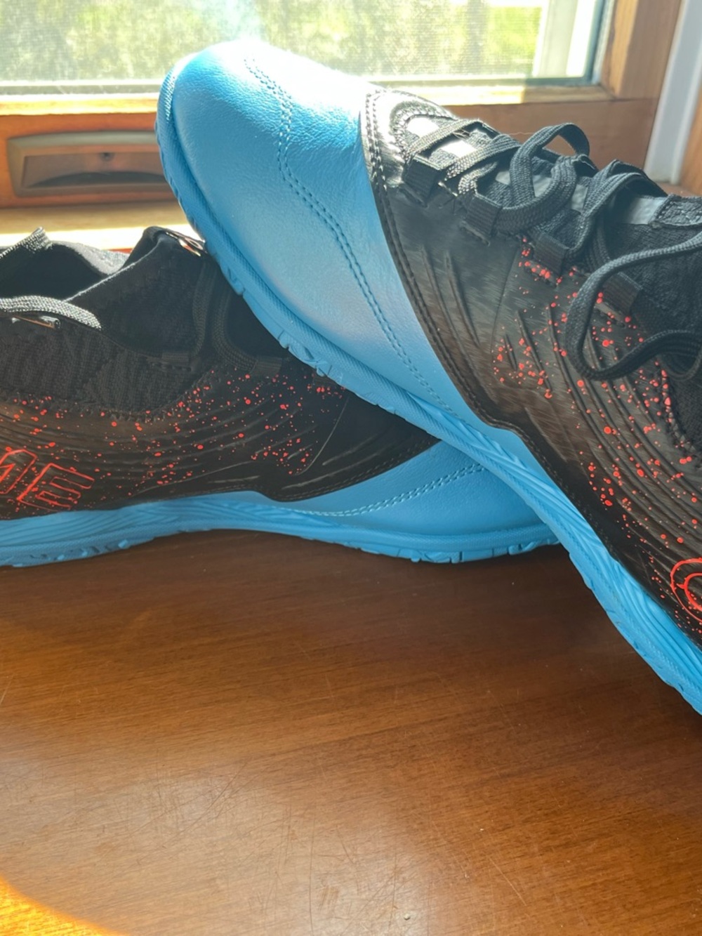 Puma Black Sneakers with Bright Blue Soles and Red Speckle